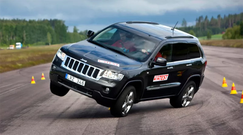 Highway Accident, black car turning right and almost overturning