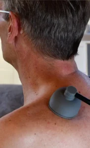 Neck Injury, cropped photo of a shirtless man with a medical instrument near his neck