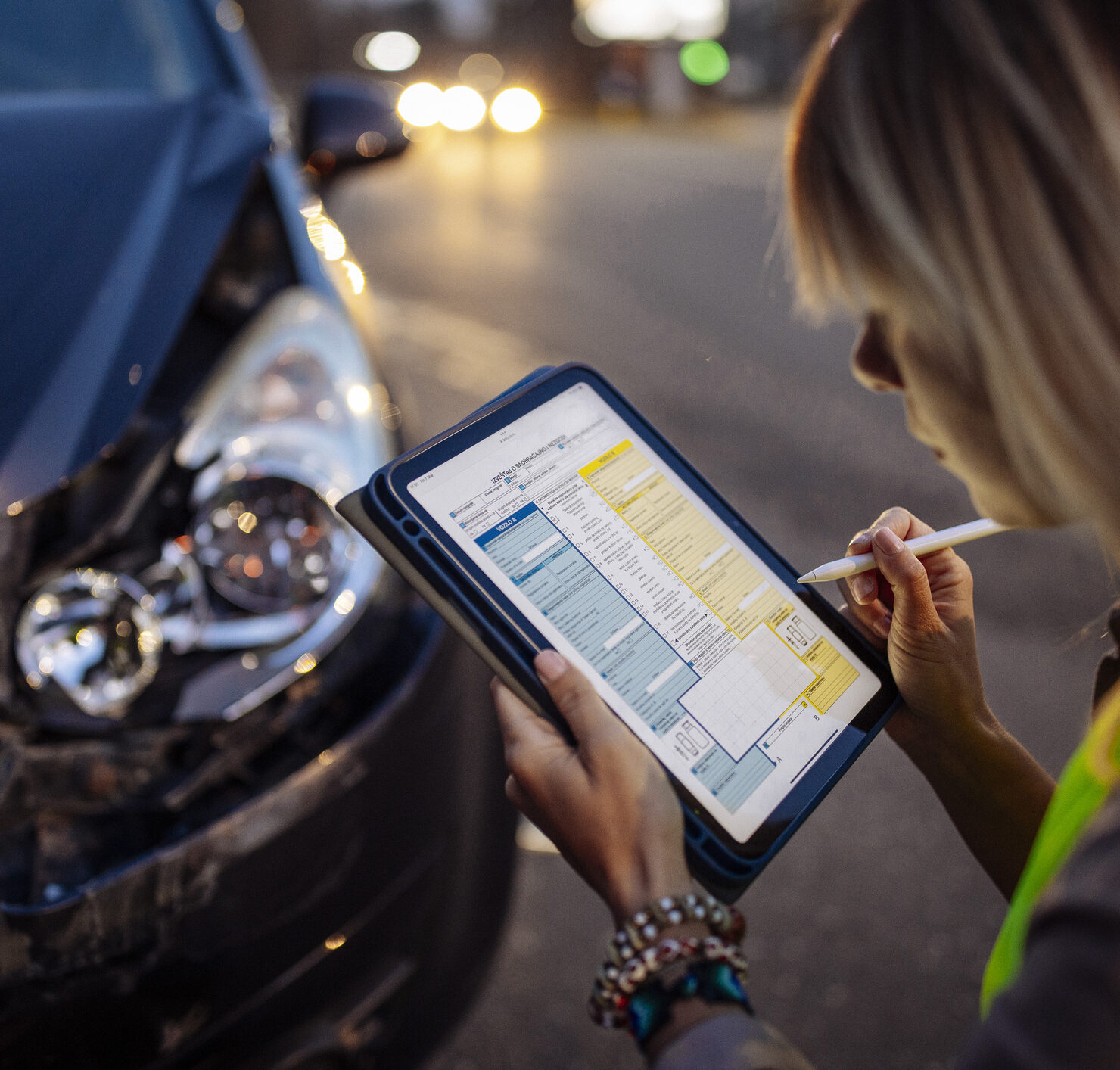 Woman filling accident report after car crash